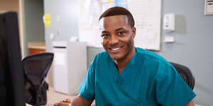 Medical assistant looking into camera